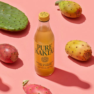 A glass bottle of Pure Kaktai Lime & Ginger Sparkling Cactus Water with the prickly pear cactus.